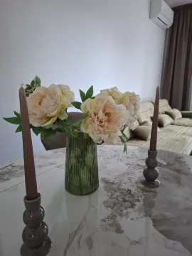 Dining table with flowers and candles in the living room. - image 4