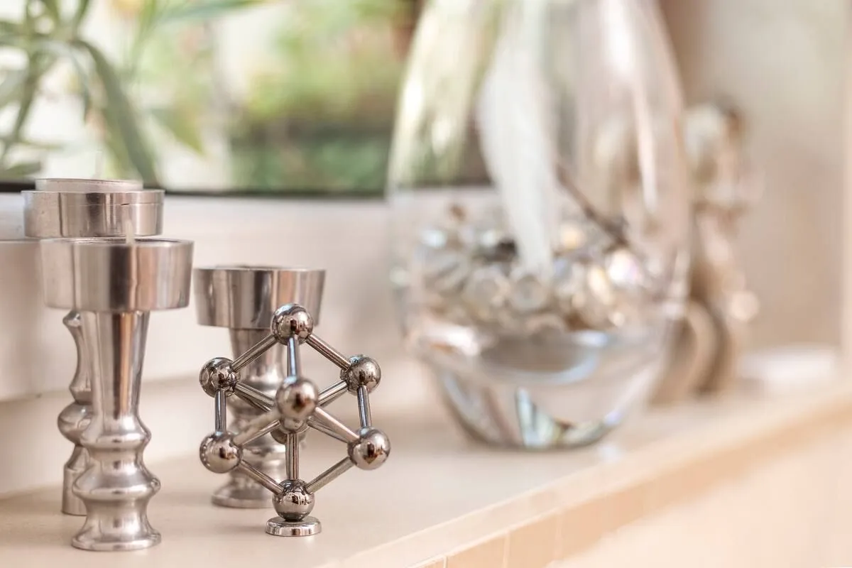 Interior detail showing decorative candle holders and a vase on a shelf.