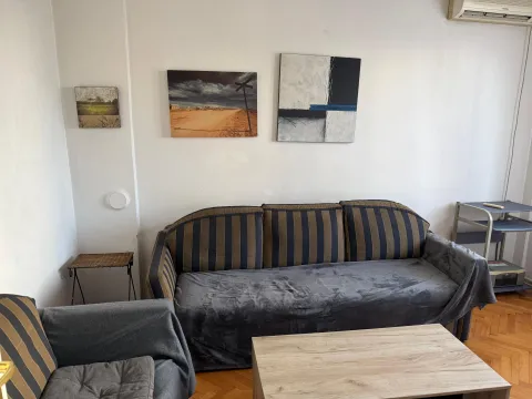 Living room with a sofa set and paintings on the wall. - image 10