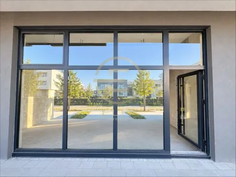 View of the entrance area of a commercial space with large glass surfaces. - image 7