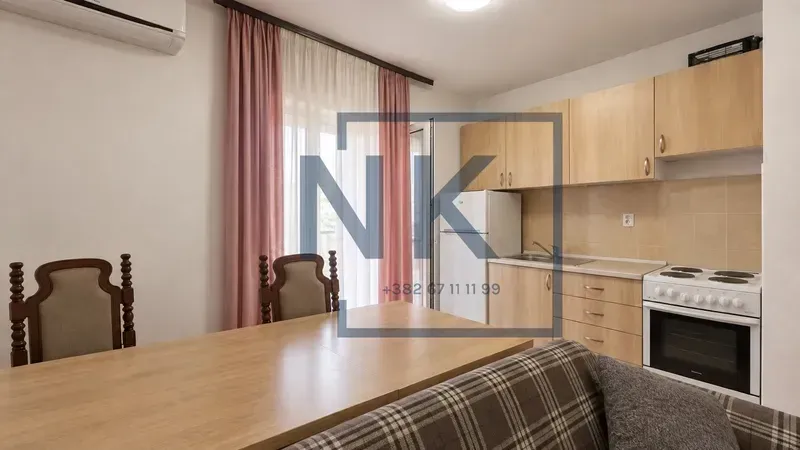 Living room with dining area and an open kitchen.