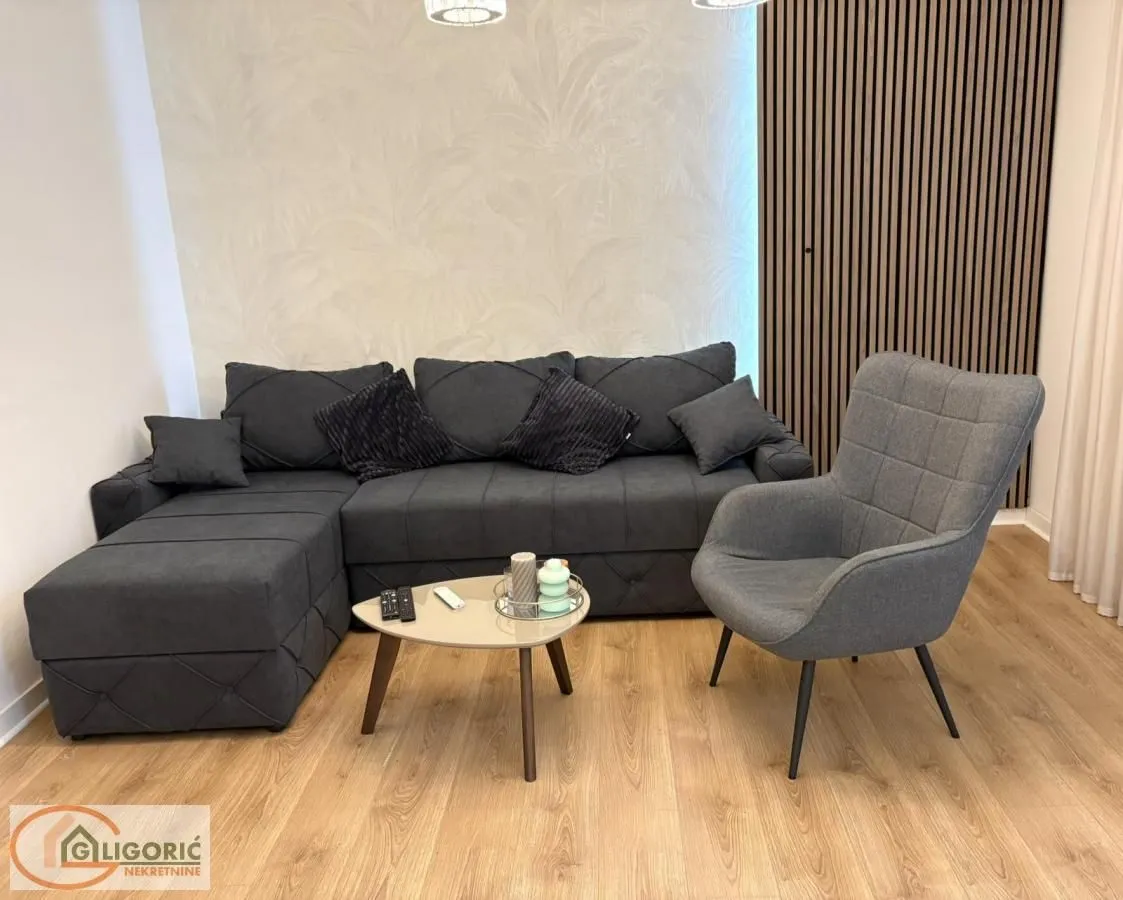 Living room with a sectional sofa, armchair, and coffee table.
