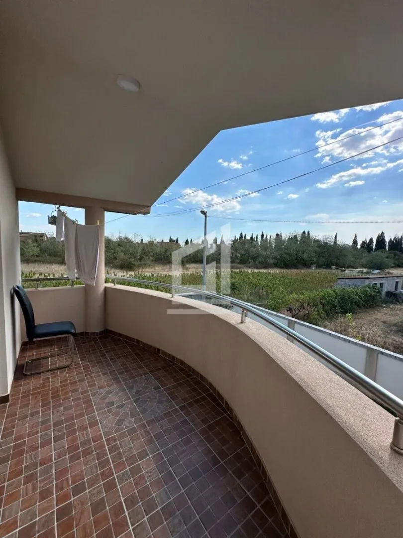Spacious covered terrace with a view of greenery and surroundings.