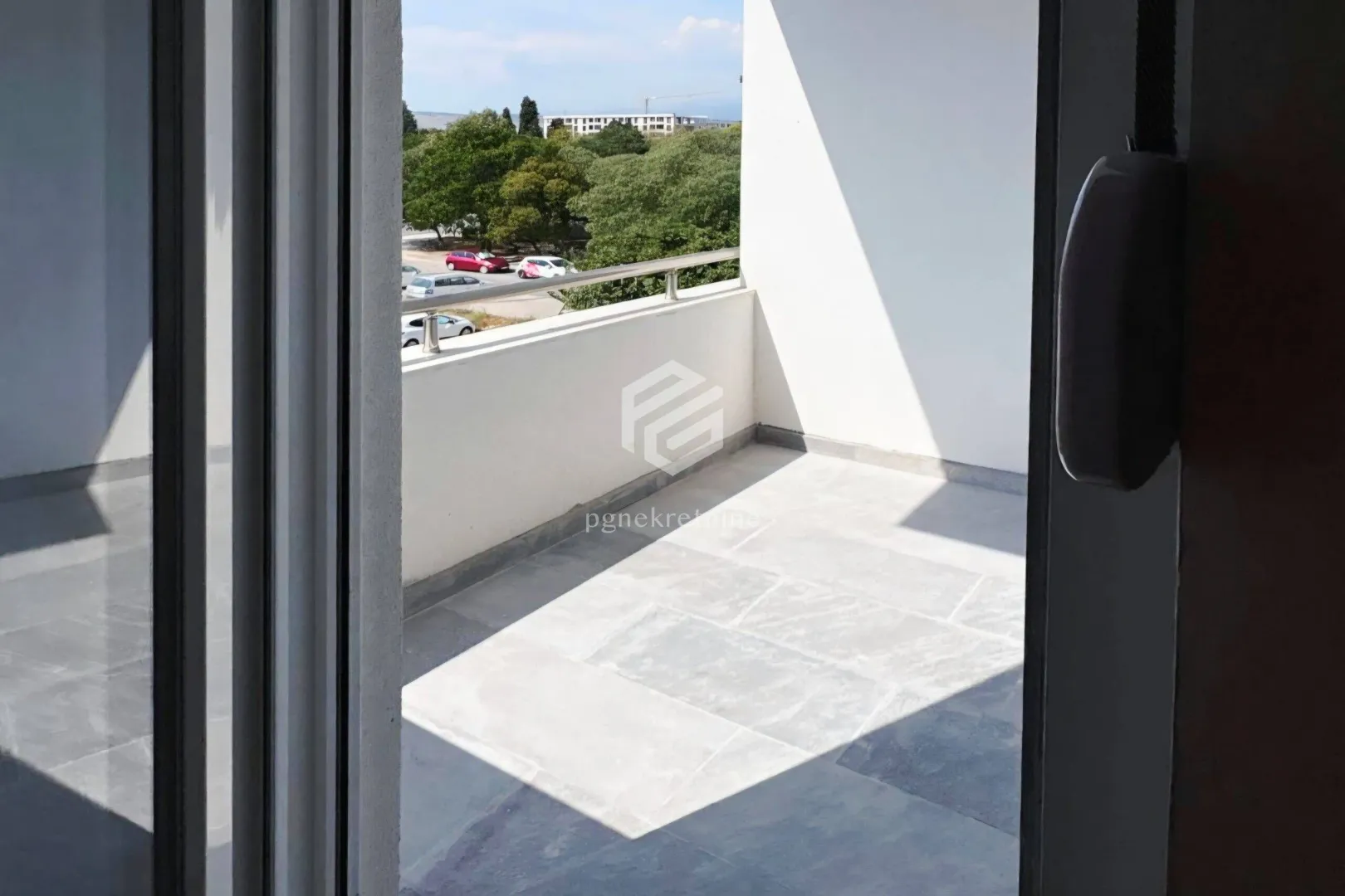View of a spacious balcony with a railing and a view of the surroundings.