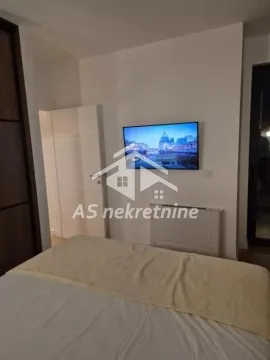 Bedroom with a double bed and a wall-mounted TV. - image 20