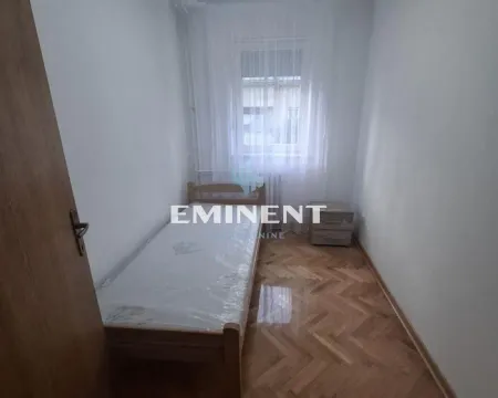 Smaller bedroom with a bed and parquet flooring. - image 6