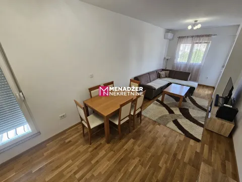 Living room with dining area, sofa set, and wooden flooring. - image 2