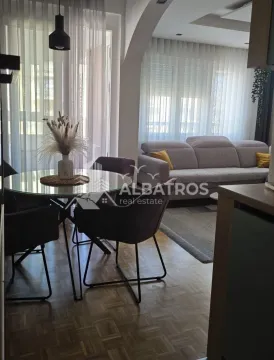 Living room with a dining area and sofa. - image 2