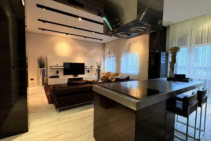 Modern kitchen with an island in an open-plan space with the living room.