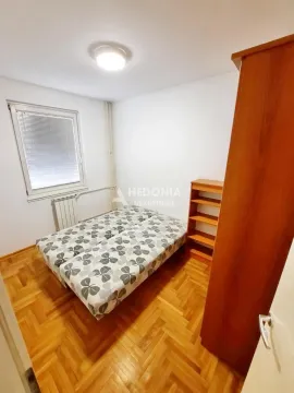 Smaller bedroom with a bed, wooden flooring, and a wardrobe. - image 9