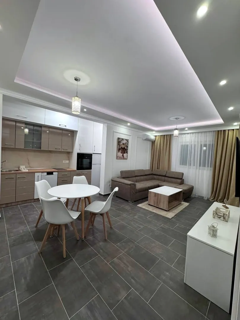 Open-plan living room with kitchen and dining area.
