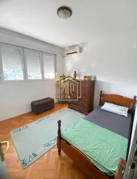 Furnished bedroom with a wooden bed, chest of drawers, and a window. - image 6