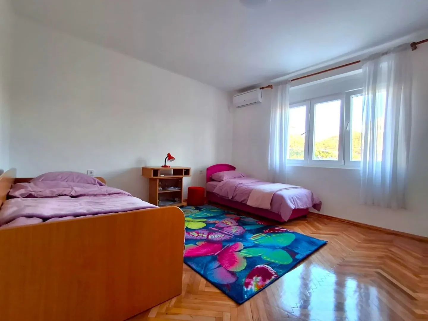 Bright children's bedroom with two beds.