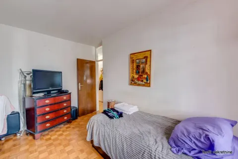 Bedroom with a bed, dresser and television. - image 10