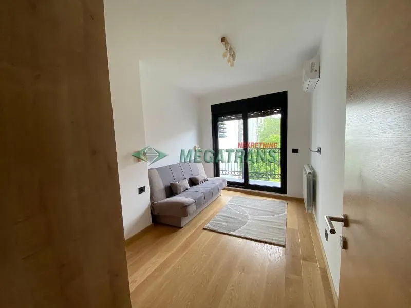 Small living room with a sofa and access to the terrace.