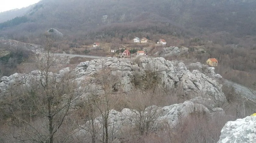 Pogled sa imanja na planinski pejzaž i okolne kuće.