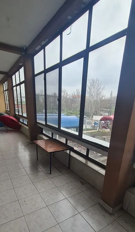 Enclosed terrace with large windows and a view of the surroundings.