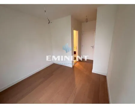 Empty unfurnished room with wooden flooring and a doorway leading to the hallway. - image 16