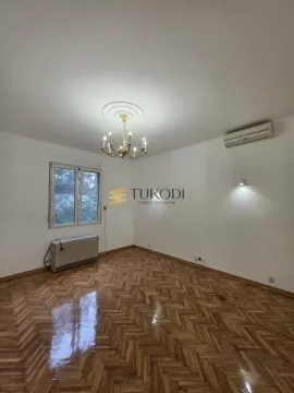 Empty room with parquet flooring and a chandelier on the ceiling. - image 11