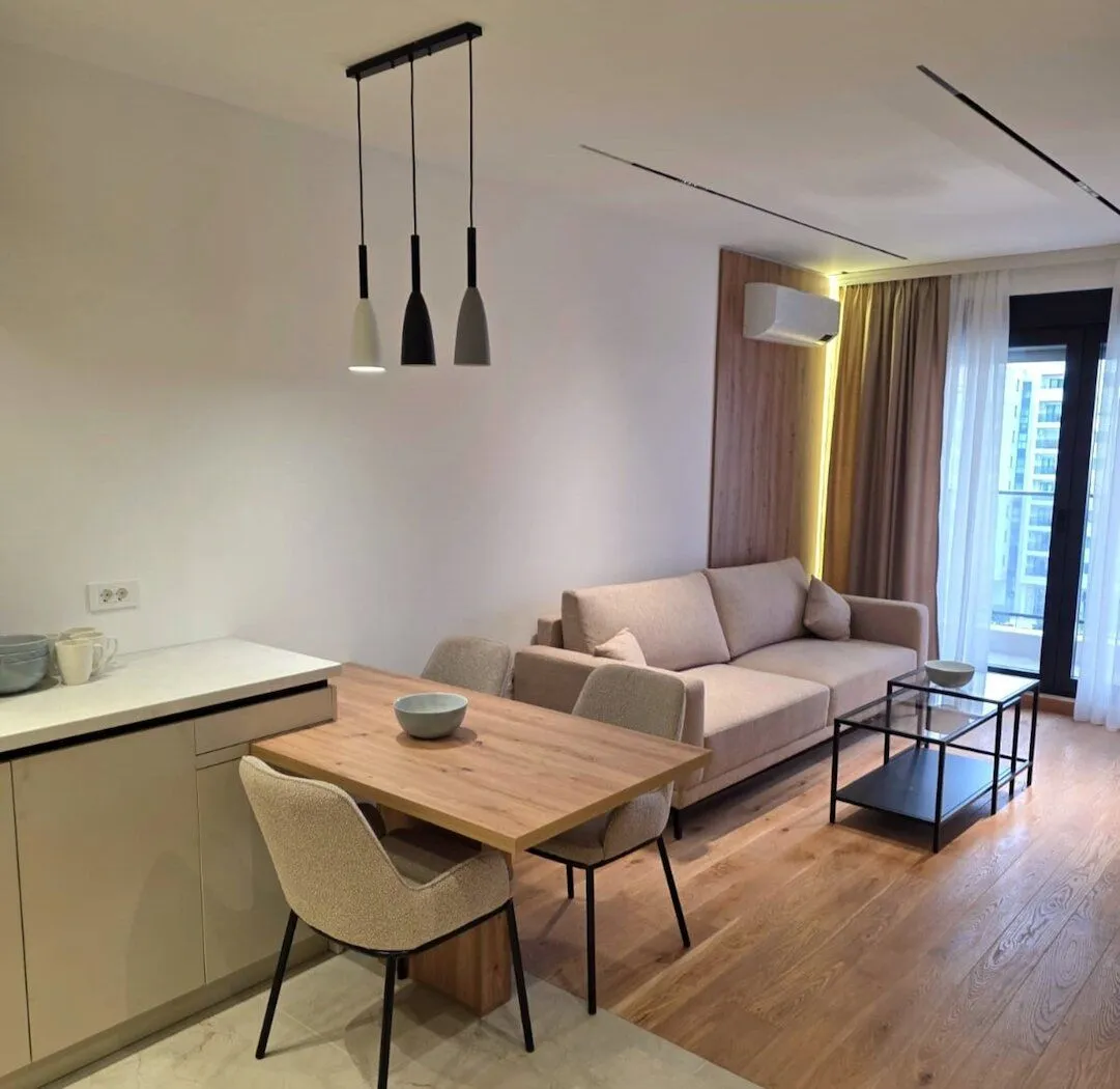 Modern living room with dining area and sofa.