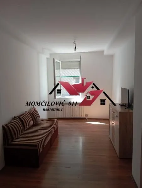 Living room with a sofa and a TV cabinet.
