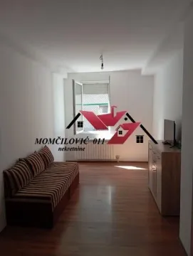 Living room with a sofa and a TV cabinet. - image 4