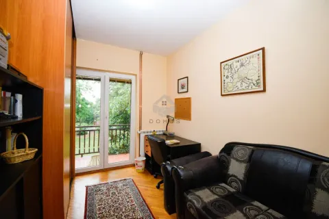 Small living room with a sofa set, a desk, and access to the balcony. - image 12