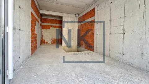 Unfinished space under construction with concrete and brick walls. - image 2