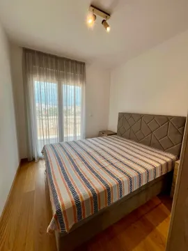 Bedroom with a double bed and balcony access. - image 6