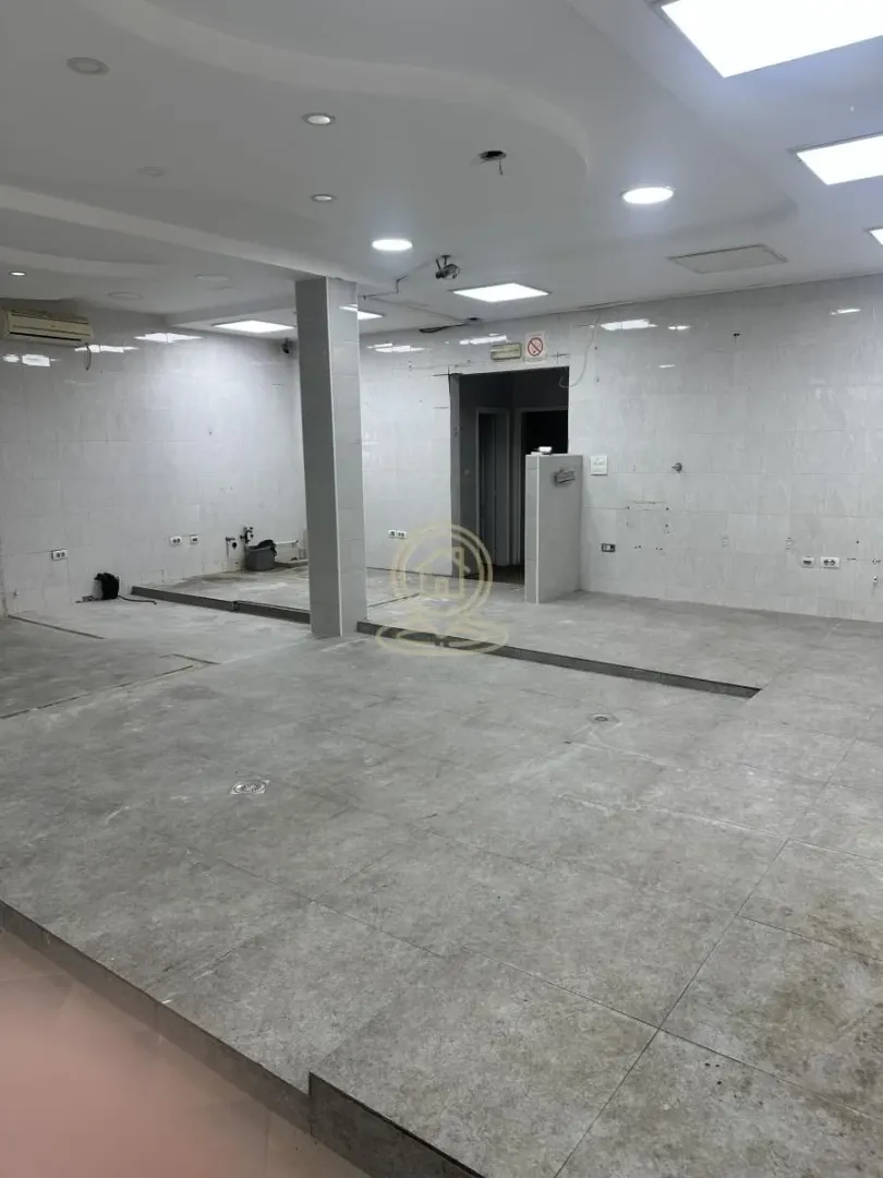 Empty room with tiled floors and walls, suitable for renovation.