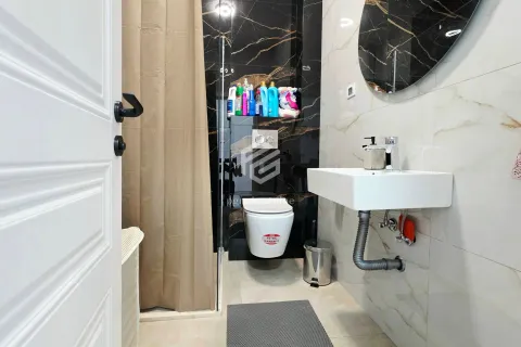 Modern bathroom with a walk-in shower, wall-hung toilet, and washbasin. - image 5
