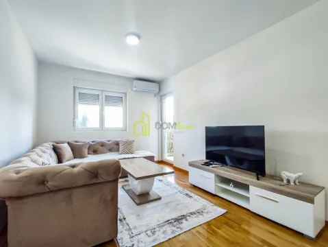Living room with a sofa, TV, and access to the terrace. - image 3