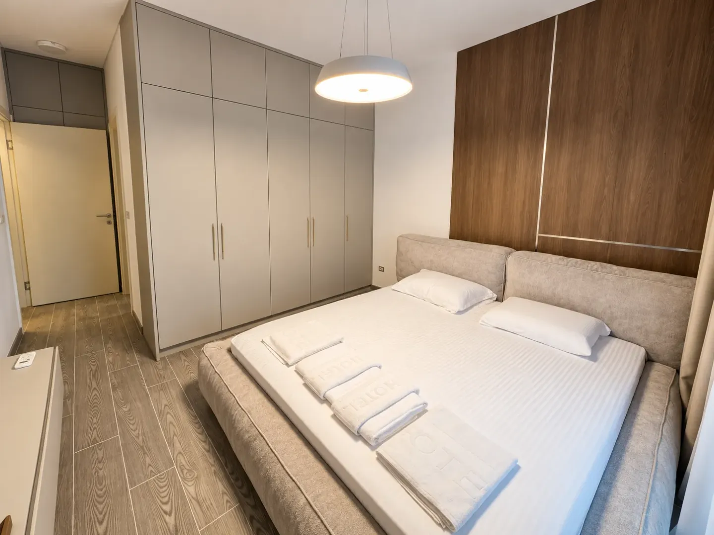 Modern bedroom with a double bed and a large fitted wardrobe.