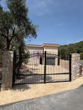 Black metal gate and fence with stone pillars in front of the house. - image 5