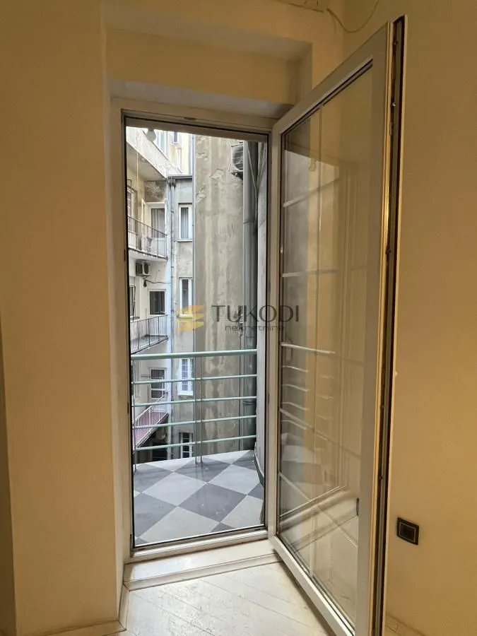 View from the balcony overlooking the inner courtyard of the building with open balcony doors.