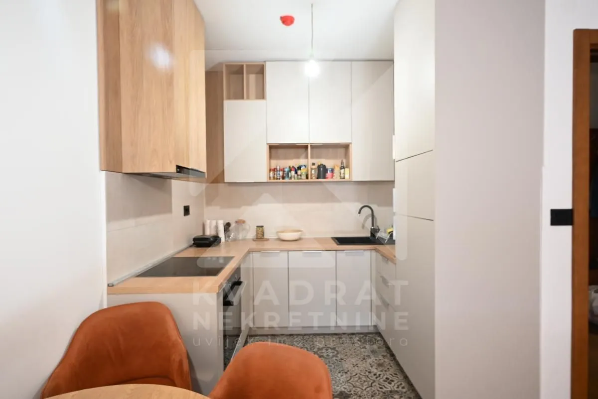 Small kitchen with wooden elements and built-in appliances.