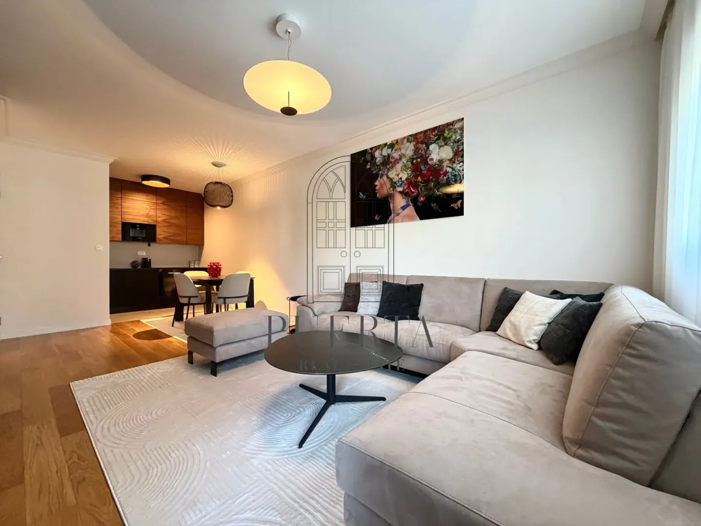 Living room with a sofa set and dining area in an open-plan layout.