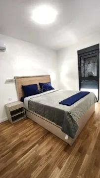Bedroom with a double bed, nightstand, and wooden flooring. - image 10