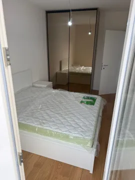 Furnished bedroom with a double bed and a large fitted wardrobe. - image 4