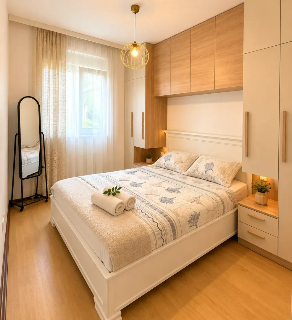 A furnished bedroom with a double bed and built-in wardrobes.