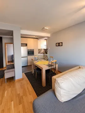Living room with dining area and kitchen in the background. - image 4