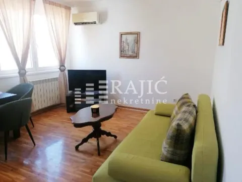 Living room with sofa, TV and dining table. - image 3