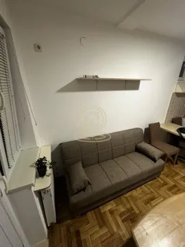 Living room with a sofa and wooden flooring. - image 2