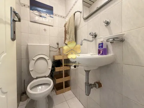 Small bathroom with a toilet, sink, and mirror. - image 11