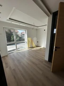 Empty room with laminate flooring, drop ceiling, and large window. - image 7