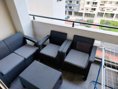 Furnished balcony with seating set and a view of the neighborhood. - image 5
