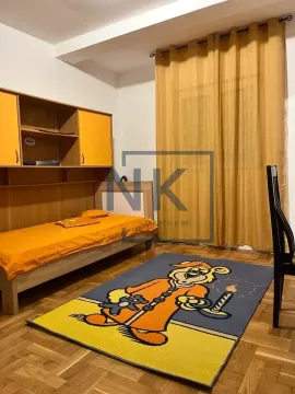 Children's bedroom with a bed, wardrobe, and cartoon-themed rug. - image 4