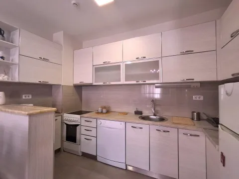 Modern kitchen with white cabinetry and built-in appliances. - image 5