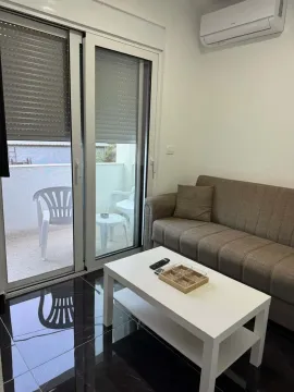 Living room with a sofa, coffee table, and access to the terrace. - image 2