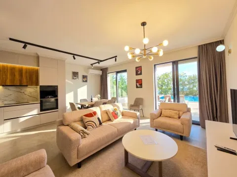 Living room connected to the kitchen and dining area with access to the terrace and pool. - image 2